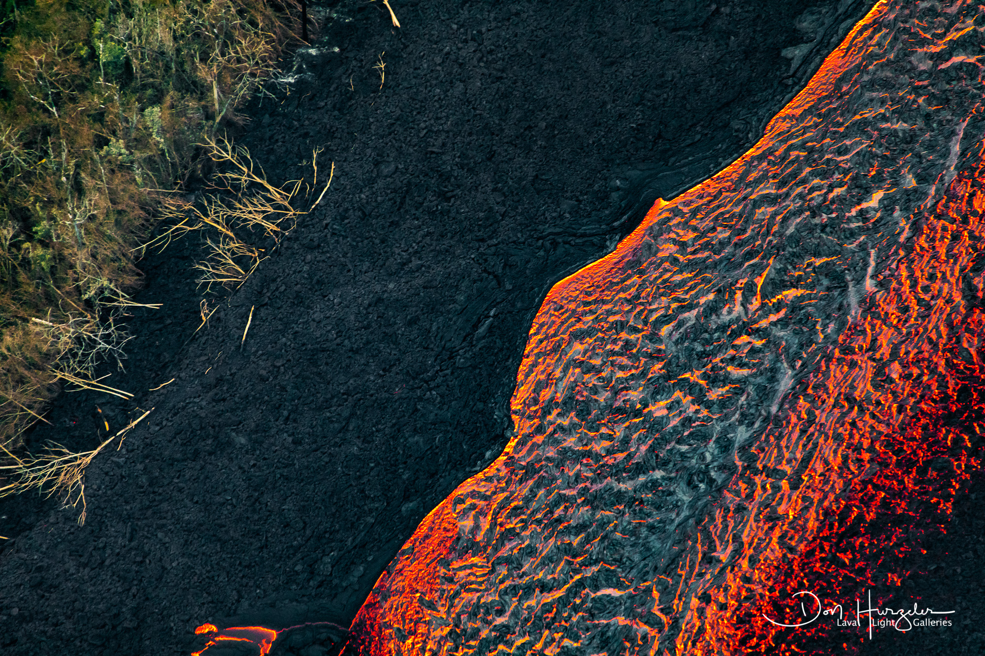 Broad Swath The dark material on top of the red river of lava is lava that is cooling. It will eventually form a tube that will insulate...