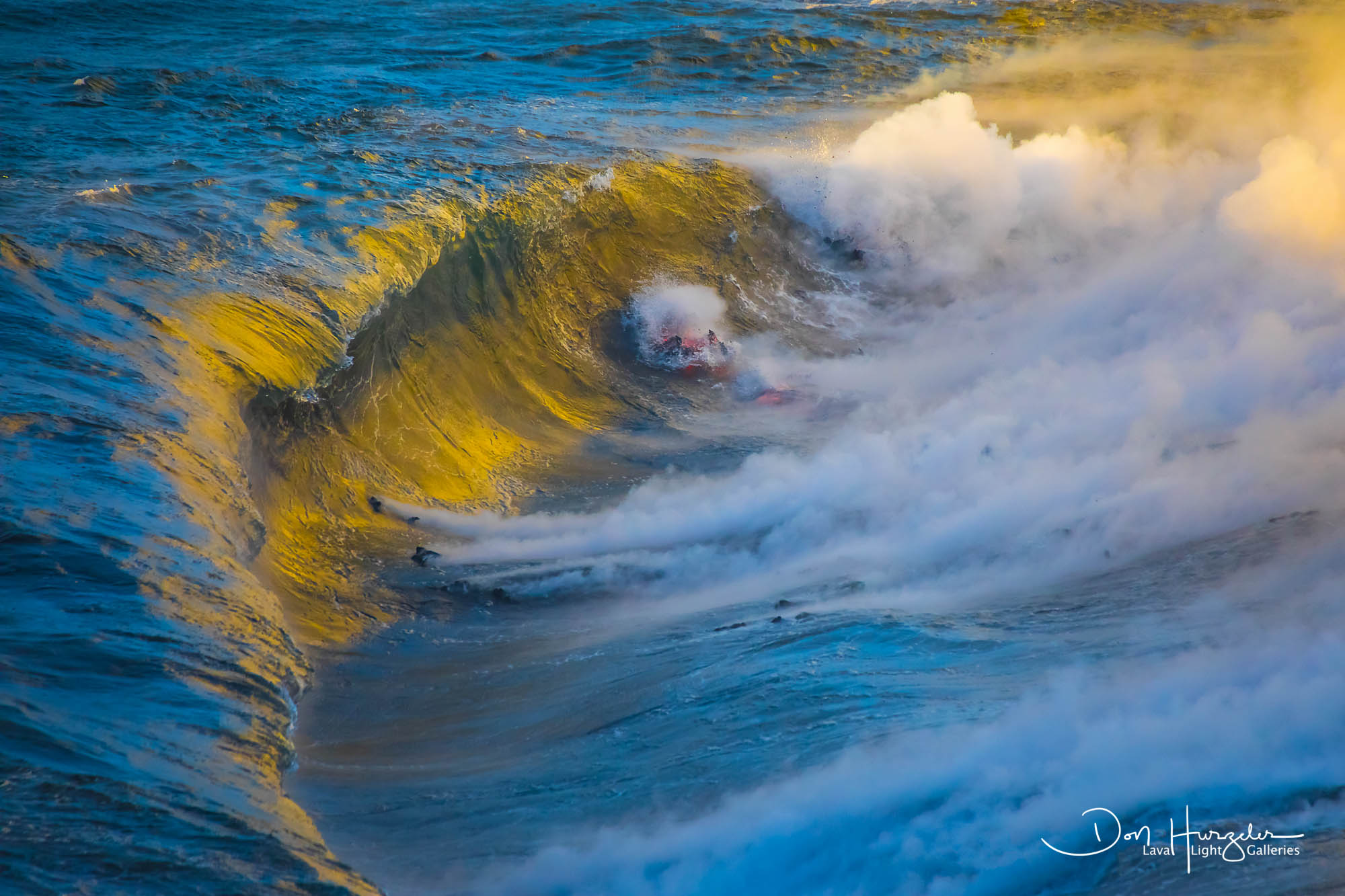 First light caught on the face of the breaking wave...with lava exploding through it.