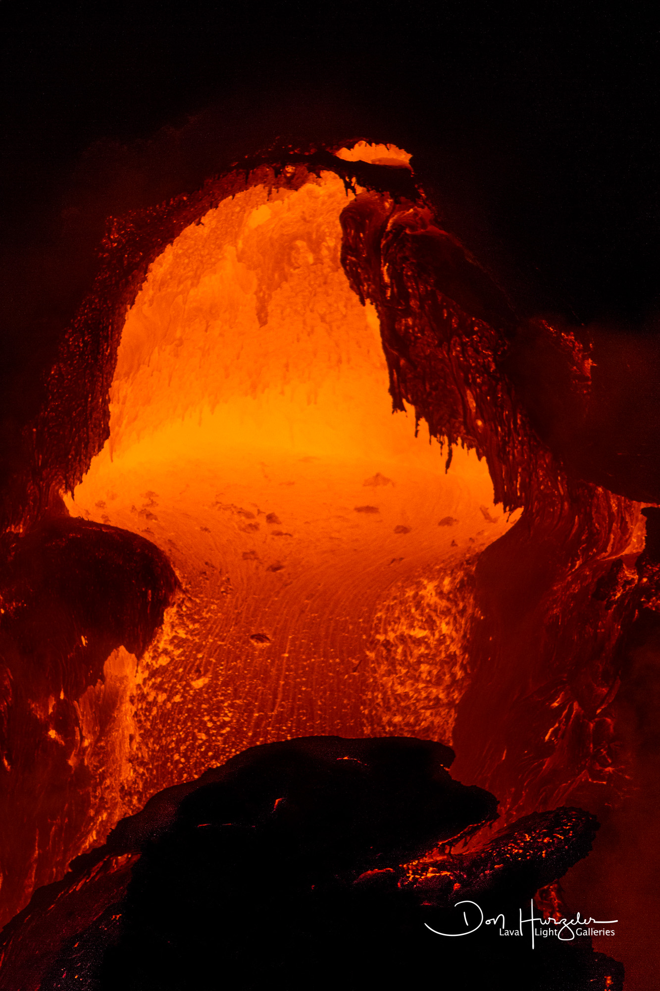 Looking directly inside a lava tube as it pours lava into the sea.
